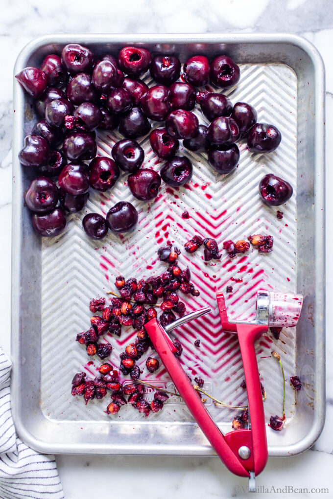 Big Cherries pitted on a sheet pan.