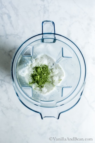 Matcha and coconut milk in a blender. 