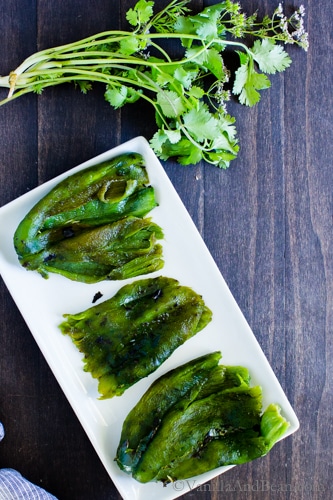 Peeled and roasted poblano peppers on a plate. 