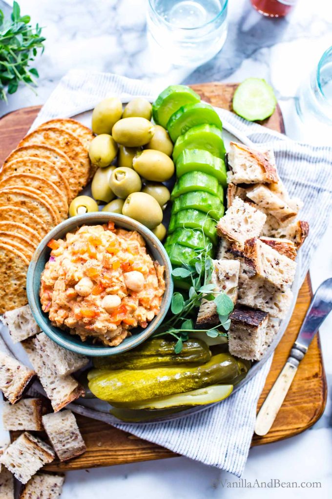 1. Vegan pimento cheese spread in a bowl surrounded with veggies and crackers