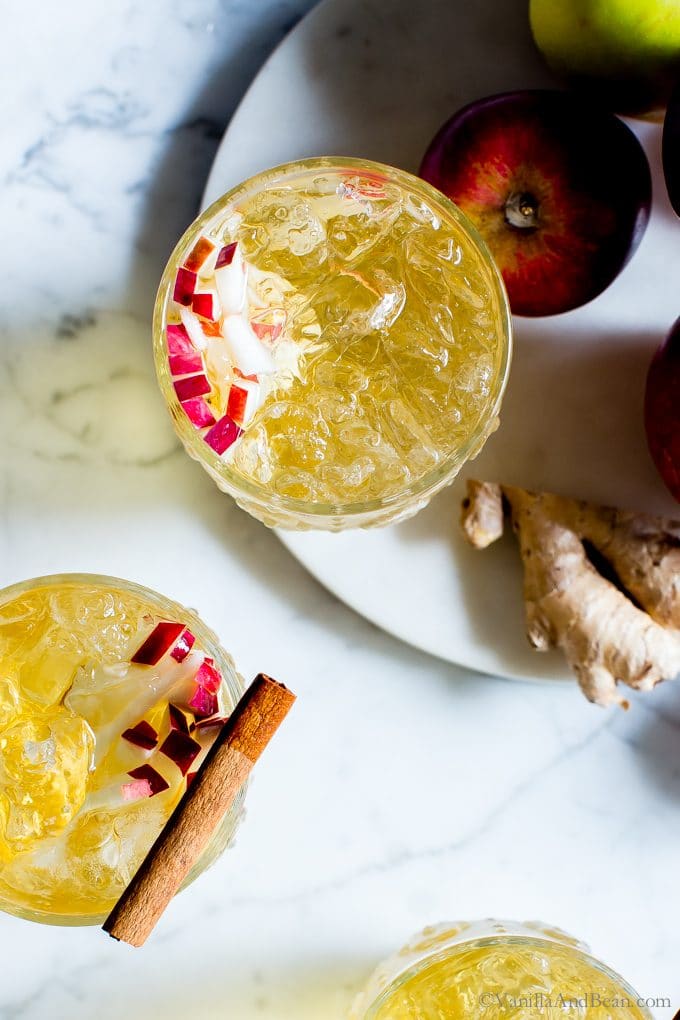 Overhead shot of Sparkling Apple Bourbon Sangria garnished with apples and a cinnamon stick. 
