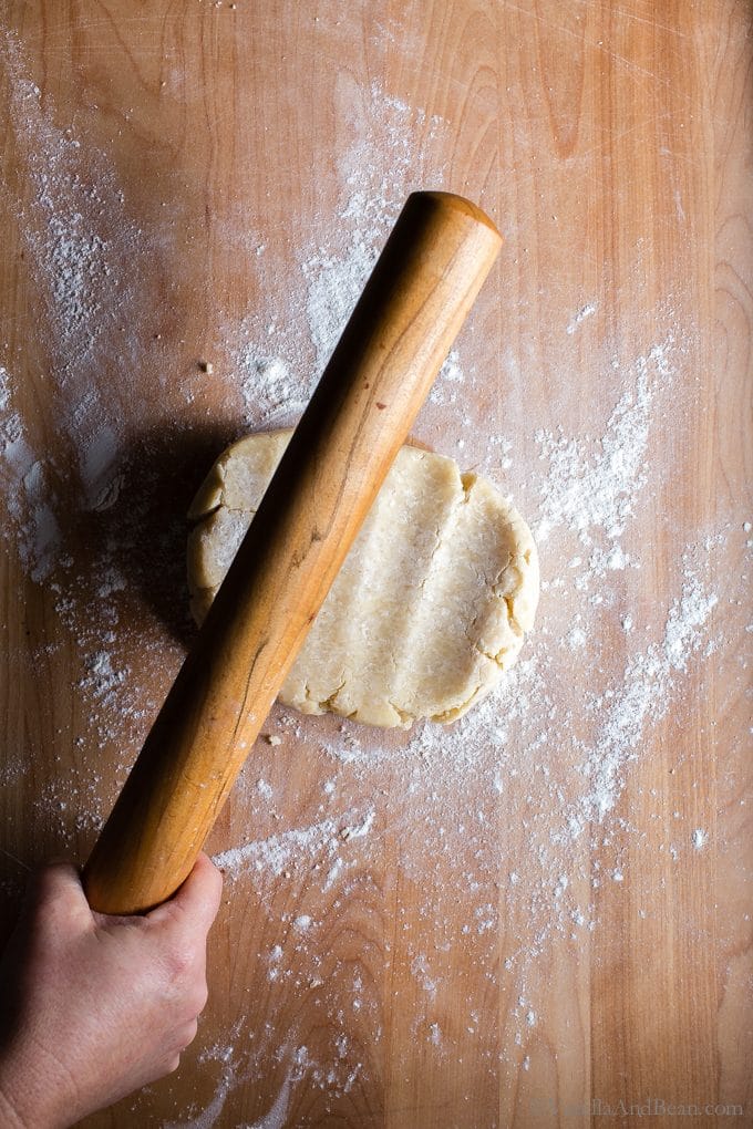 Conditioning pastry dough with a rolling pin. 