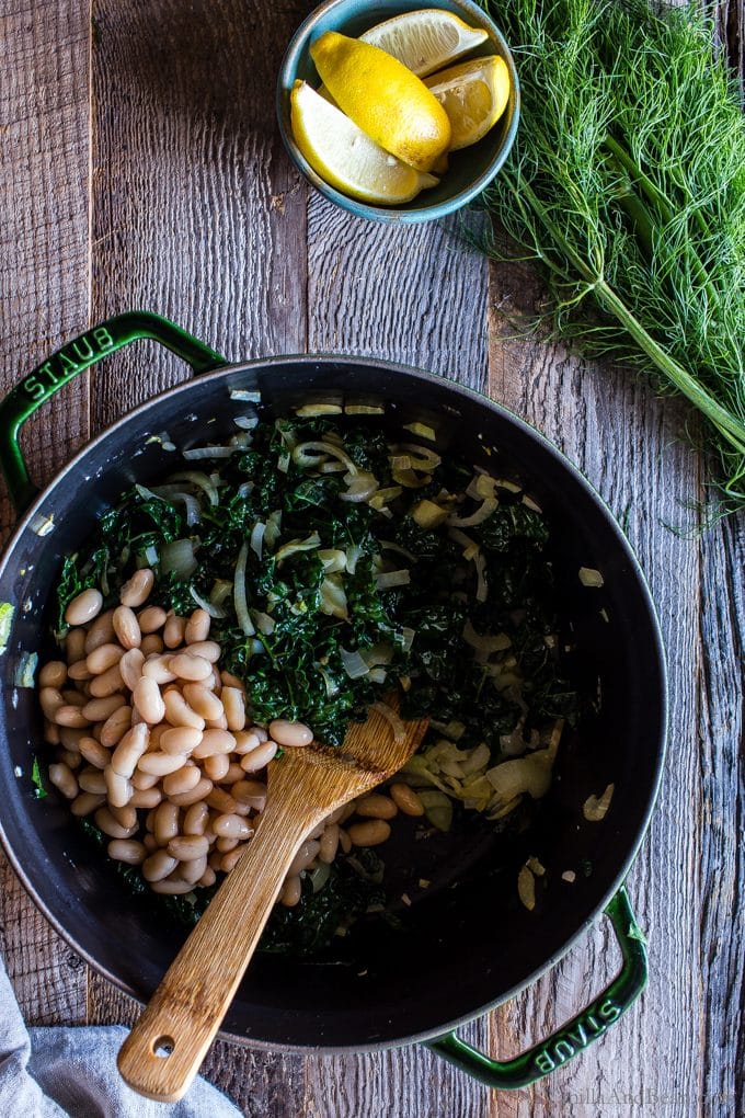 Overhead shot of Lemon-Garlic White Bean, Kale and Fennel Soup in the making in a Dutch oven. 