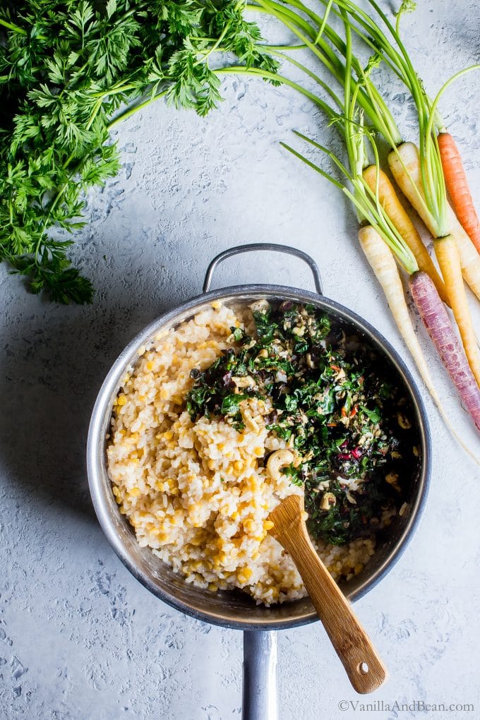 Incorporating the Swiss chard mixture into the Lentil Risotto in a pan with a spoon