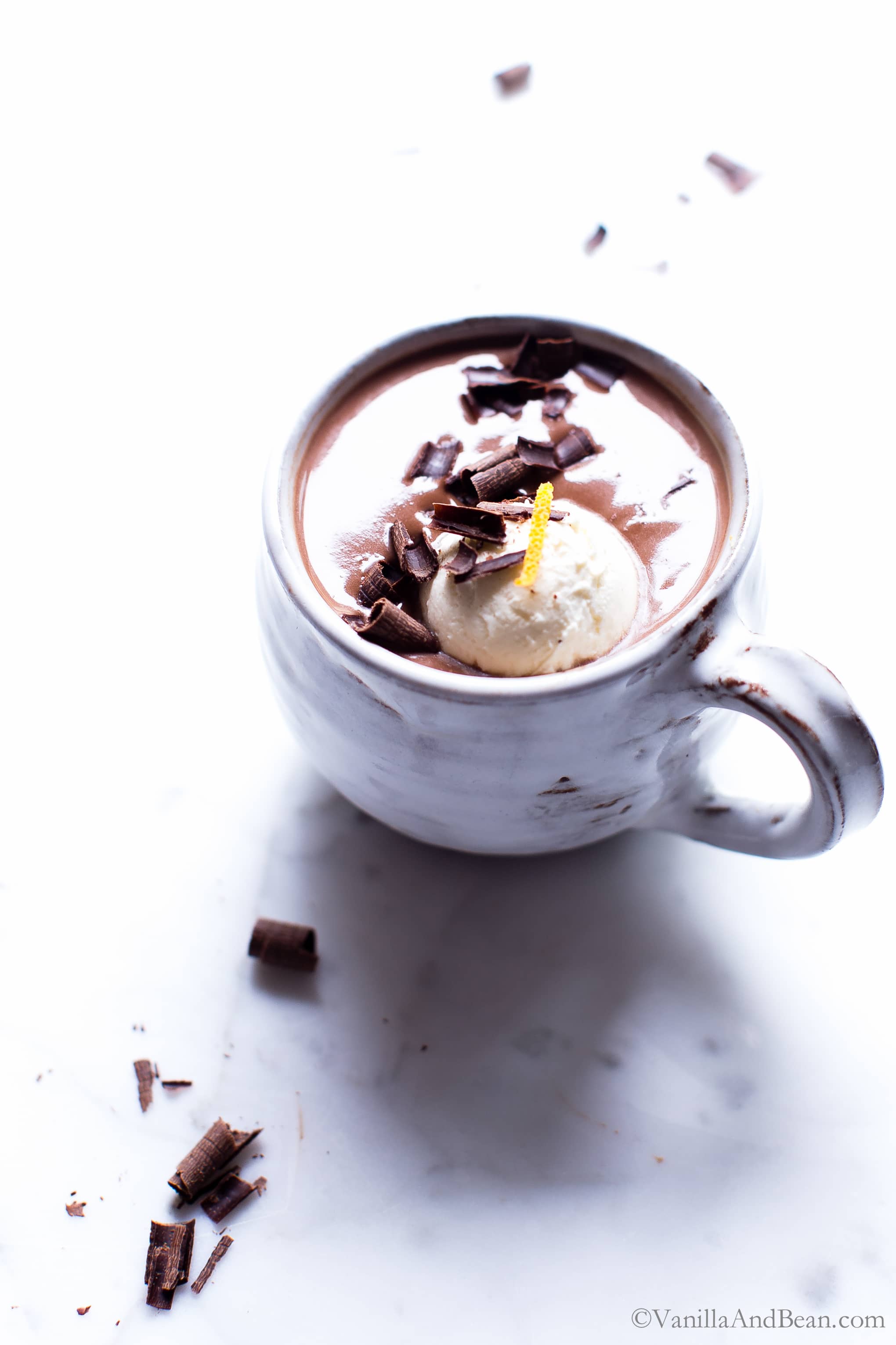 Spiked Orange Hot Chocolate in a mug with a dollop of whipped cream and chocolate sprinkles. 