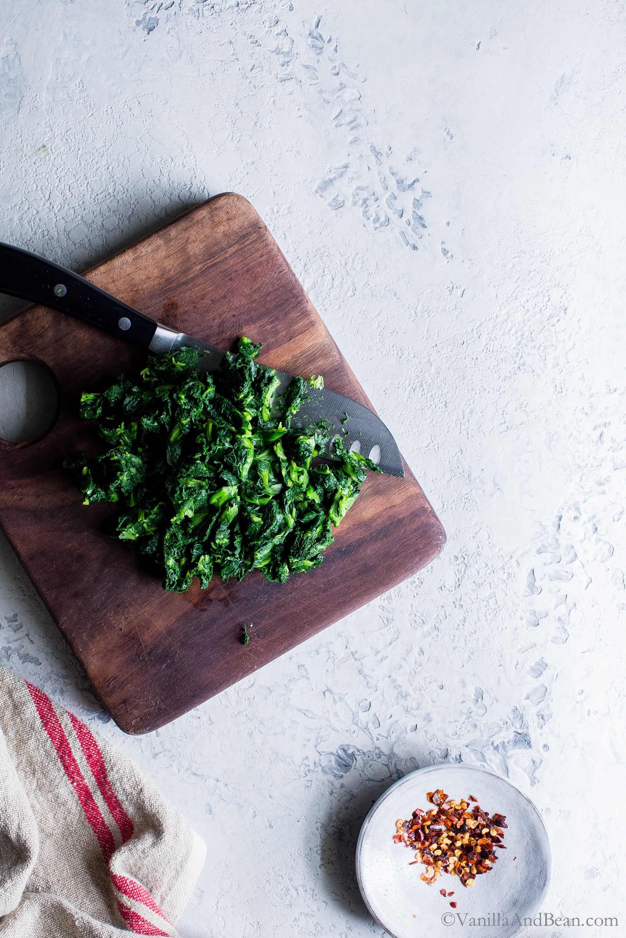 Chopping fresh blanched kale. 