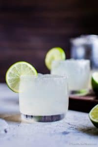 Mezcal Margarita in a glass with a lime wedge.