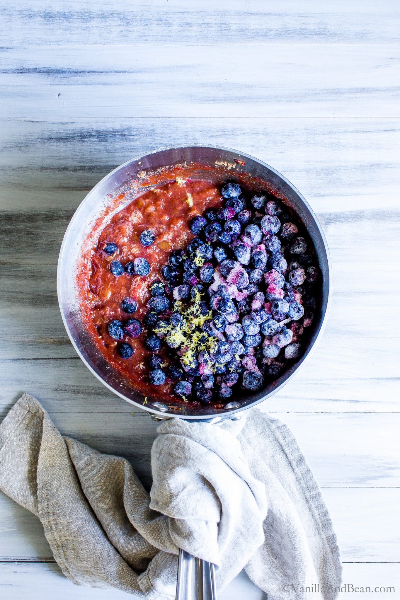 Blueberry Rhubarb Compote in a sauce pan with lemon zest. 