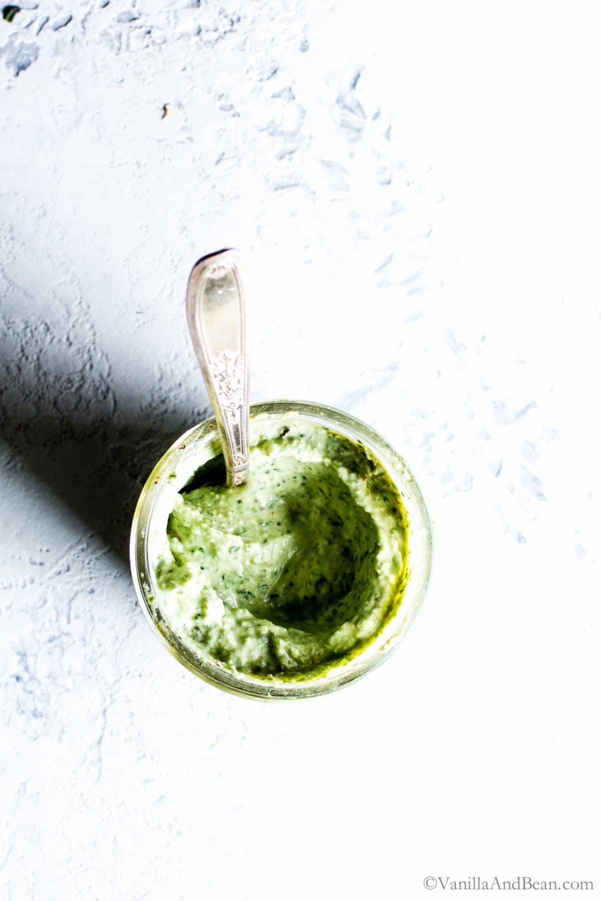 Spinach Pesto Whipped Ricotta in a jar with a spoon. 