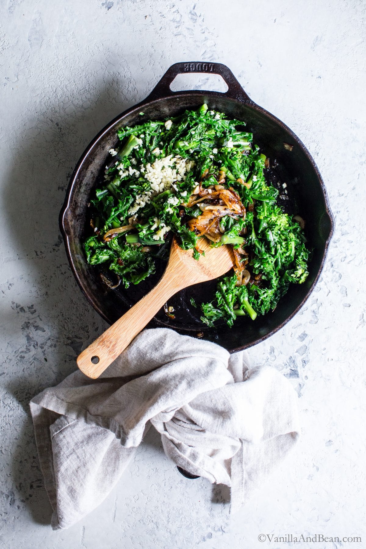 Sautéing the Broccoli Rabe and garlic in a skillet. 