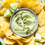 Pepita Crema in a bowl surrounded by tortilla chips.