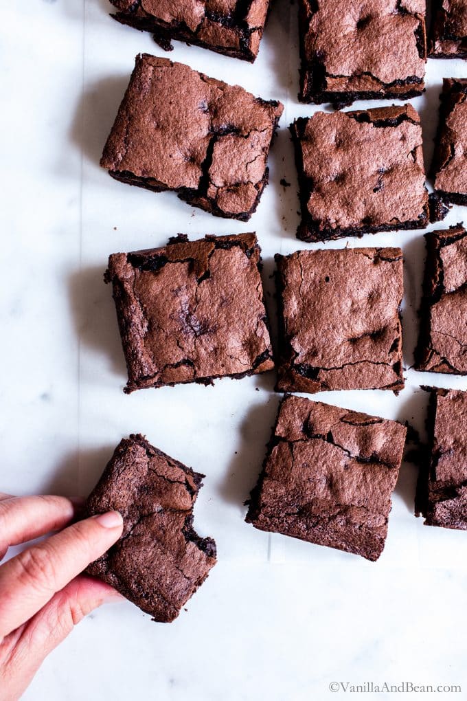 Oat Flour Brownies with a person reaching in for one. 