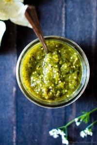 Roasted Tomatillo Salsa in a jar with a spoon!