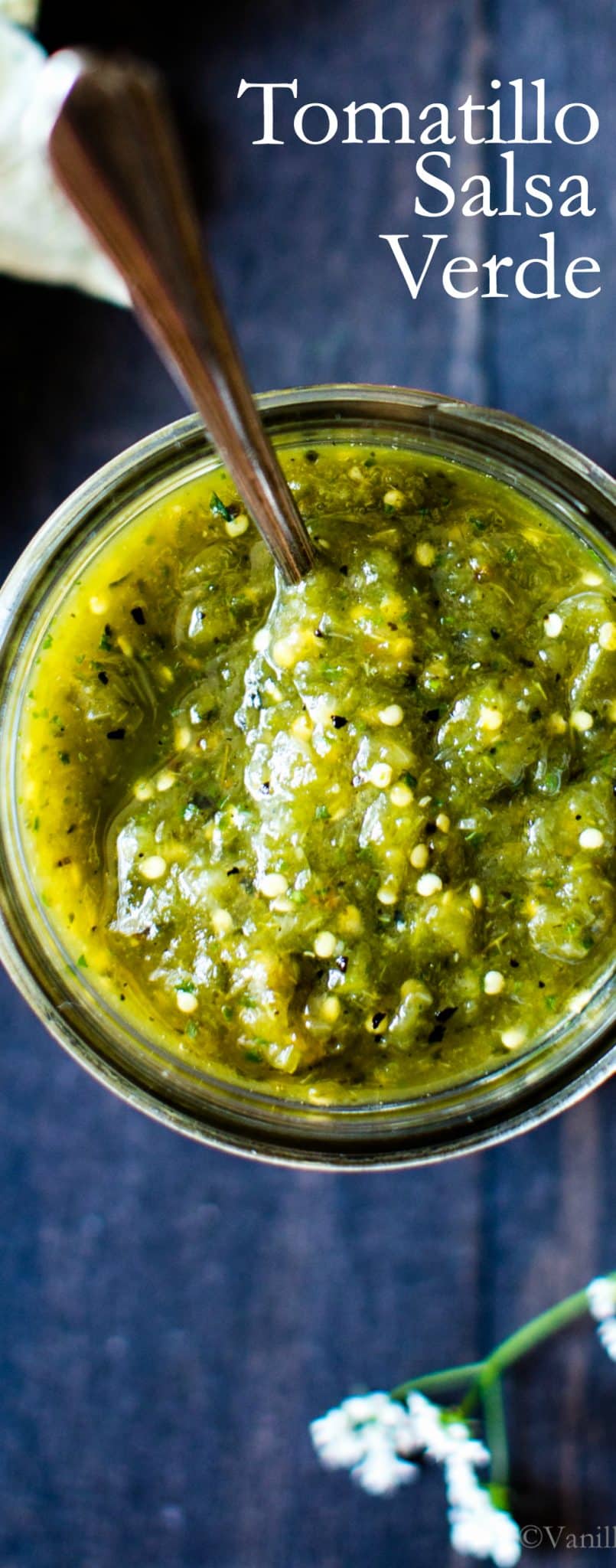 Tomatillo Salsa in a jar with a spoon. 