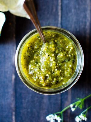 Roasted Tomatillo Salsa in a jar with a spoon!