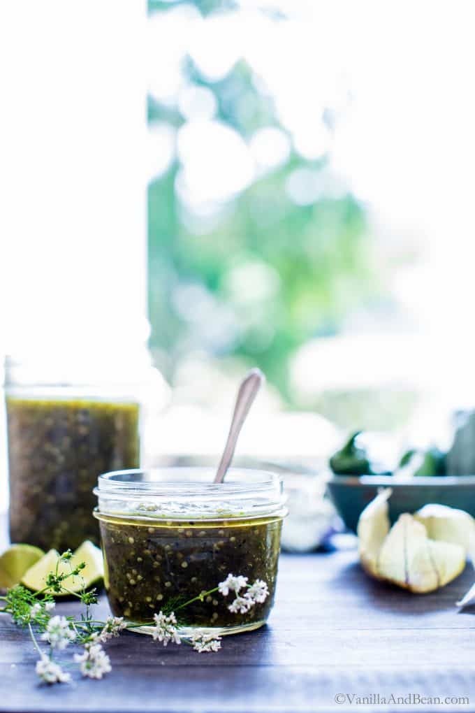 Roasted Tomatillo Salsa in a jar with a spoon! 