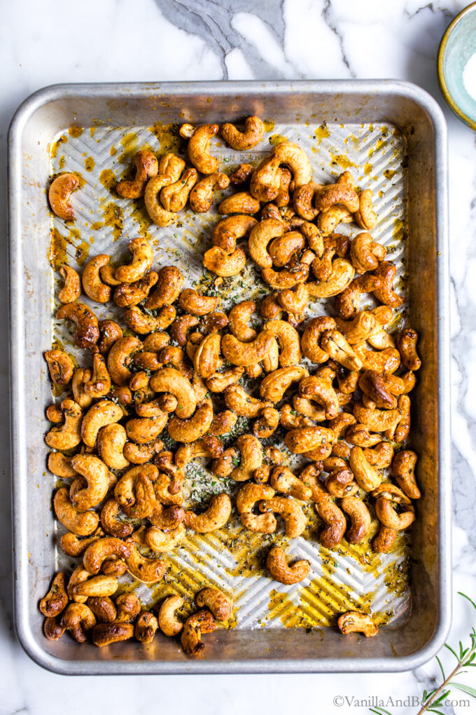 Maple roasted rosemary cashews on a sheet pan after roasting.