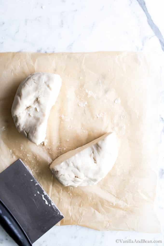 Cutting the gluten free pie pastry on parchment paper. 