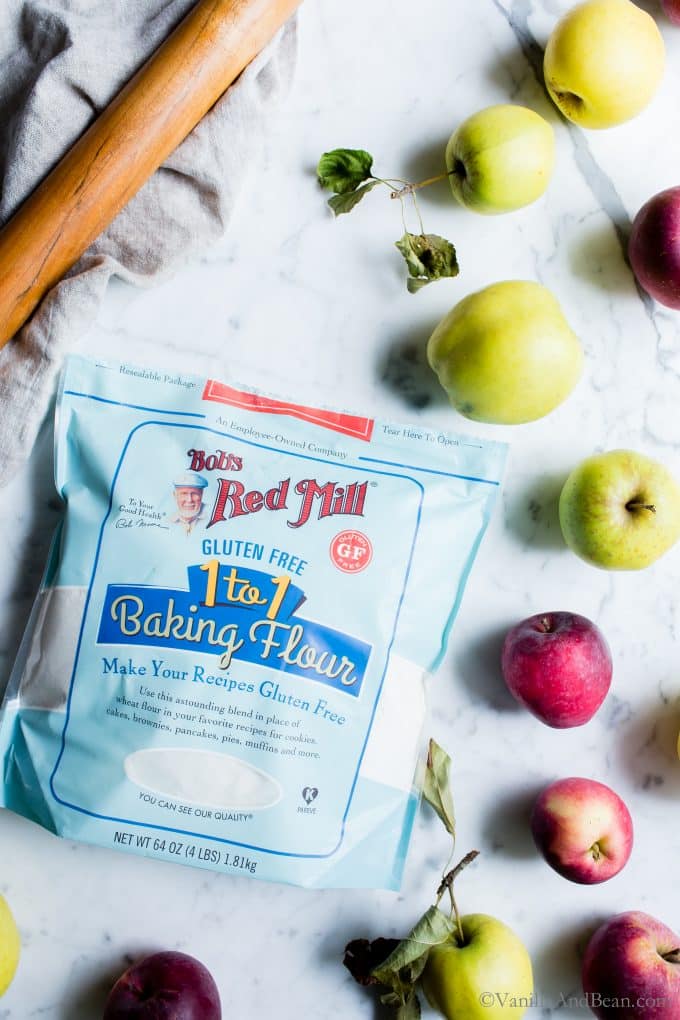Bag of Bob's Red Mill 1 to 1 Baking Flour surrounded by apples. 
