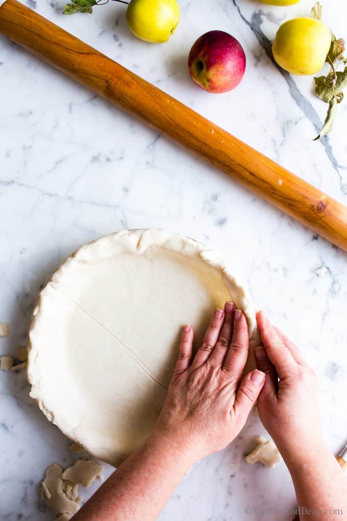 Placing the gluten free pie pastry in a pie plate.