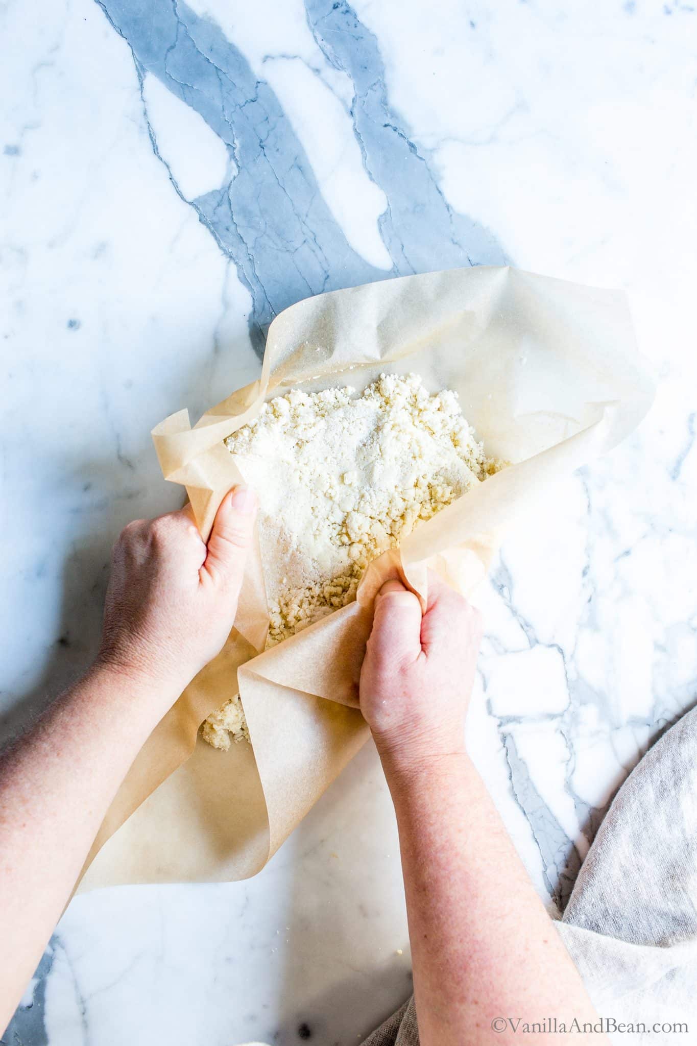 Pressing pie pastry between parchment paper. 