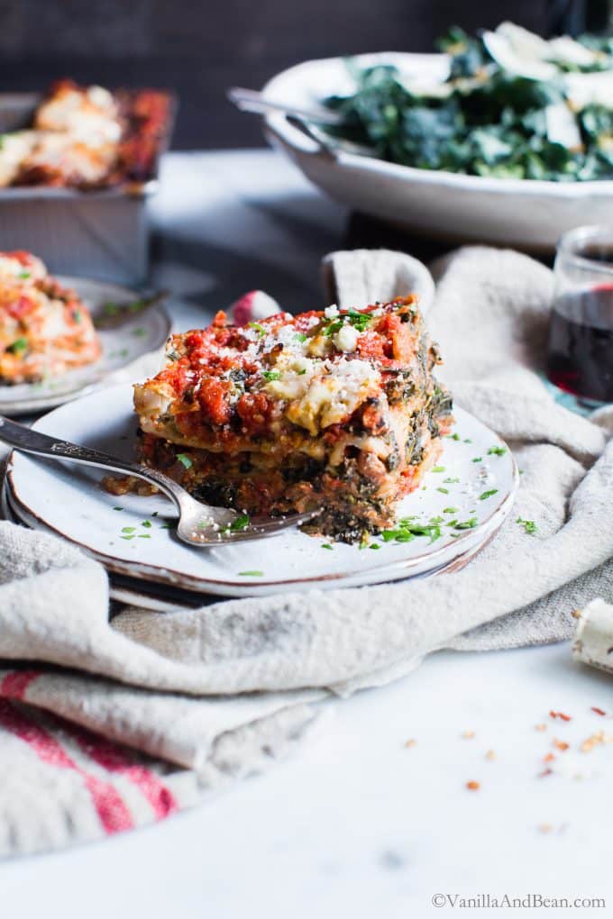 A slice of Spinach Mushroom lasagna with ricotta recipe on a plate with a fork. 