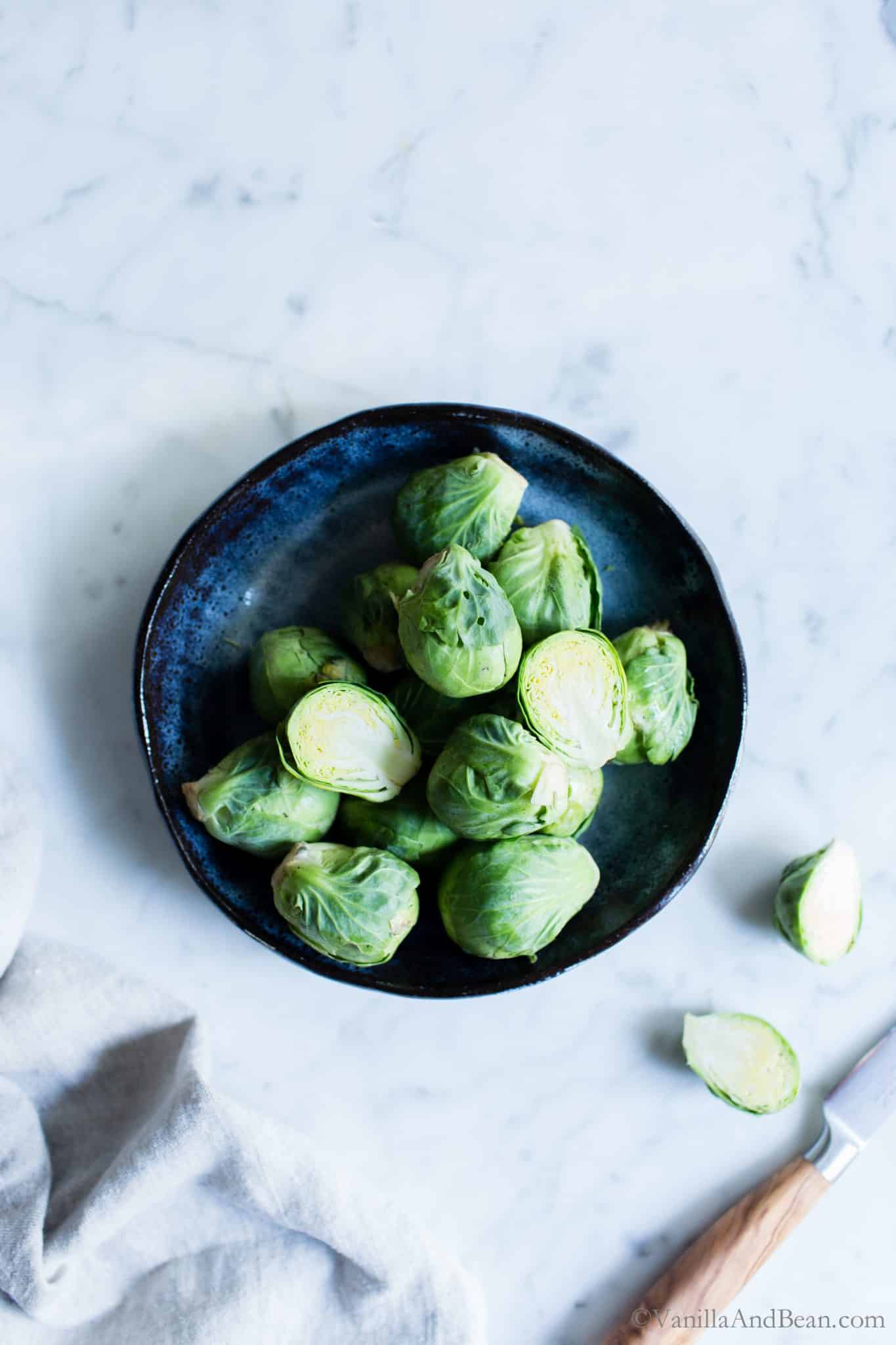  Brussels Sprouts in a blue bowl. 