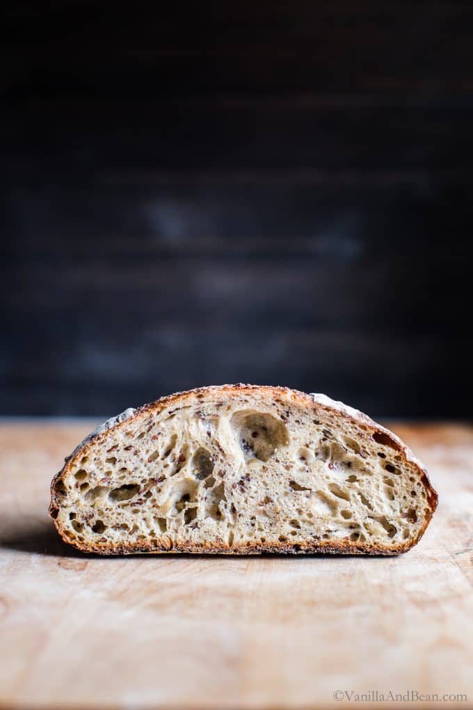 Inside crumb of Seeded Multigrain Sourdough Bread setting on a cutting board. 