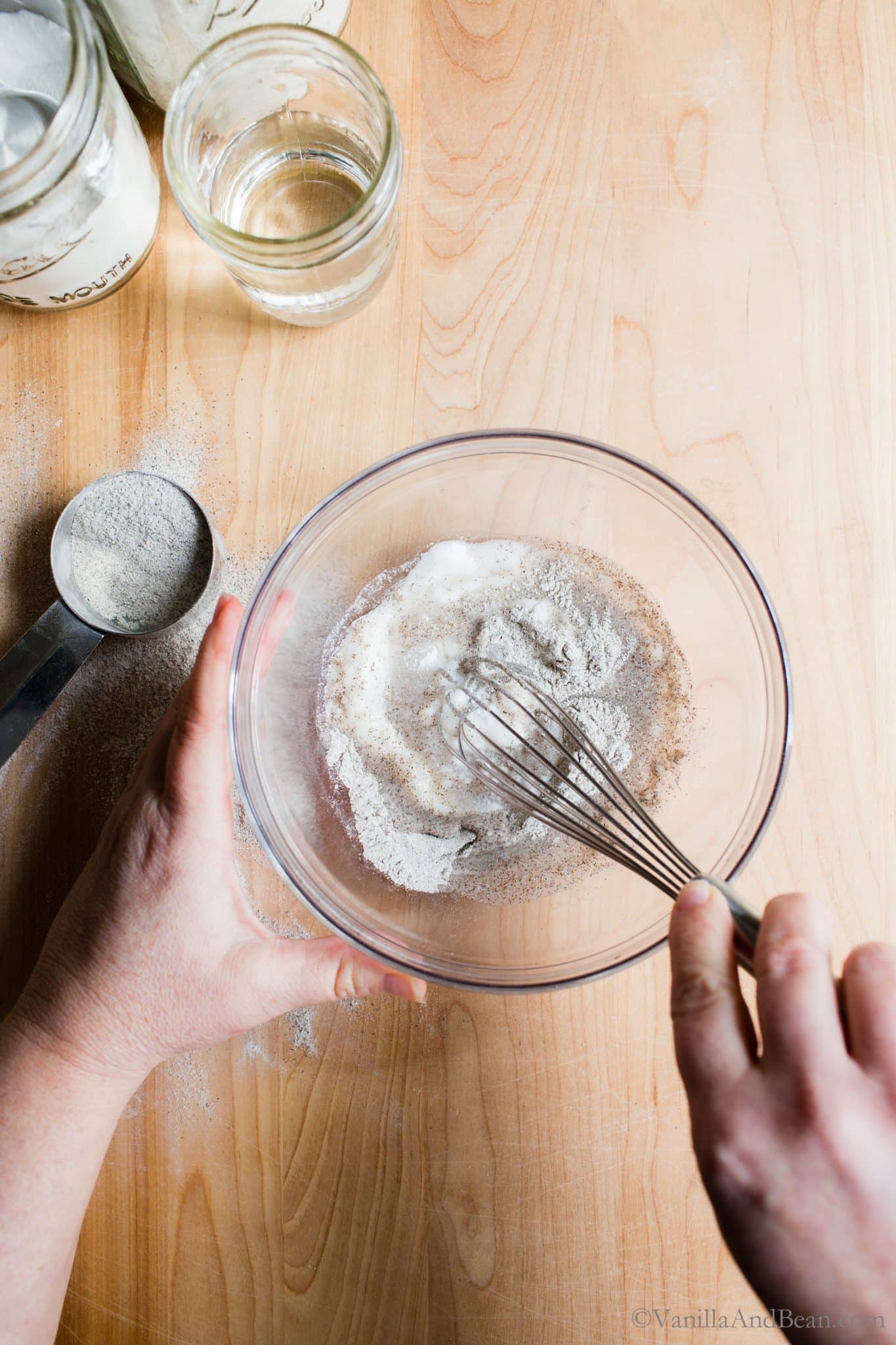 Whisking gluten free flours in a bowl with water. 