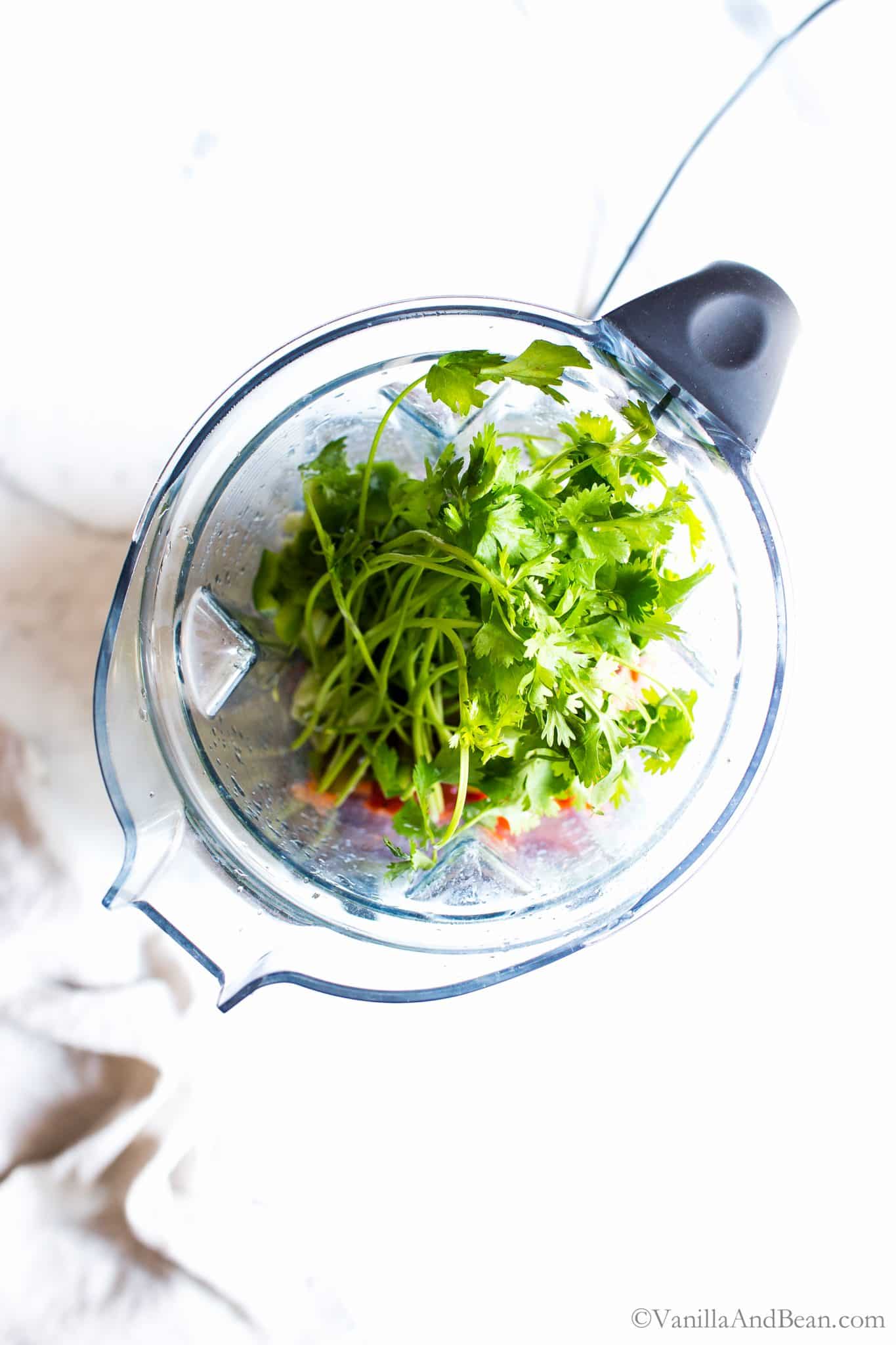 Adding lime, salt and cilantro to the mix in the blender.