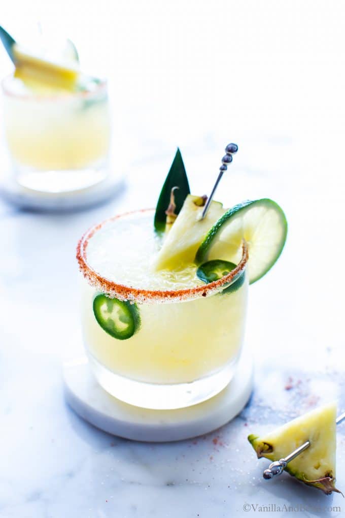 Pineapple Jalapeno Margarita garnished with lime, pineapple and jalapenos.