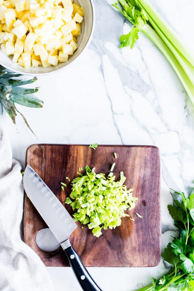 Chopping celery on a cutting board. 