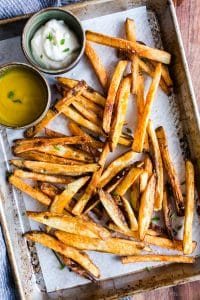 Crispy Oven Fries on a pan with two dipping sauces.