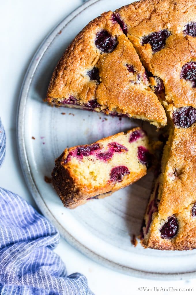 Easy Cherry Almond Cake Recipe cut into pieces and already missing a few