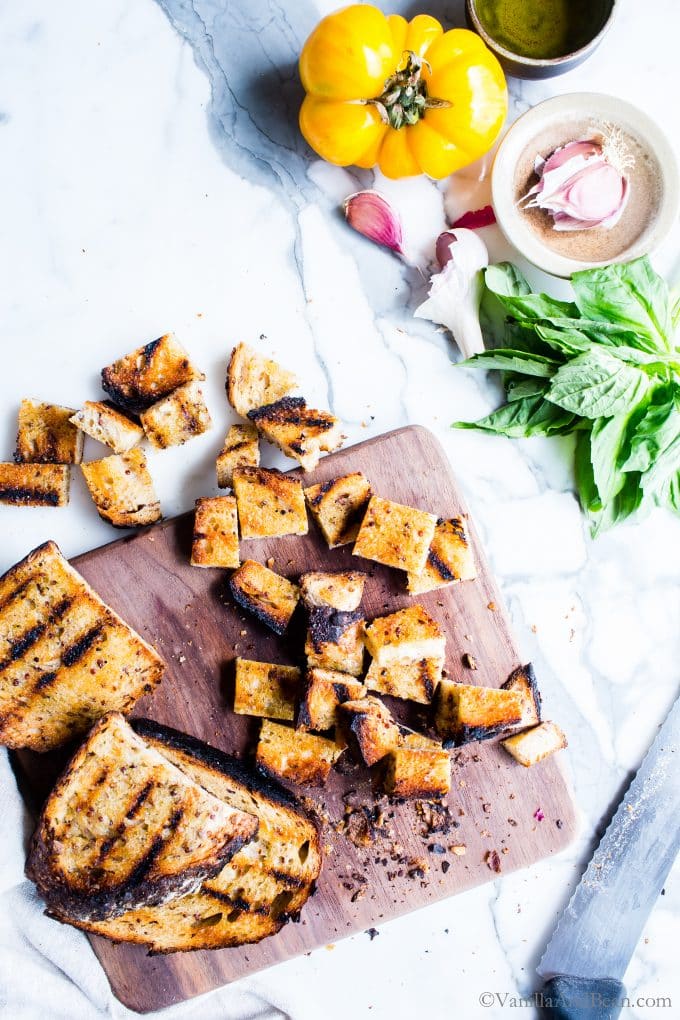 Grilled Sourdough cut into bite size pieces on a cutting board. 