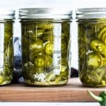 A close up of pickled jalapenos in jars.