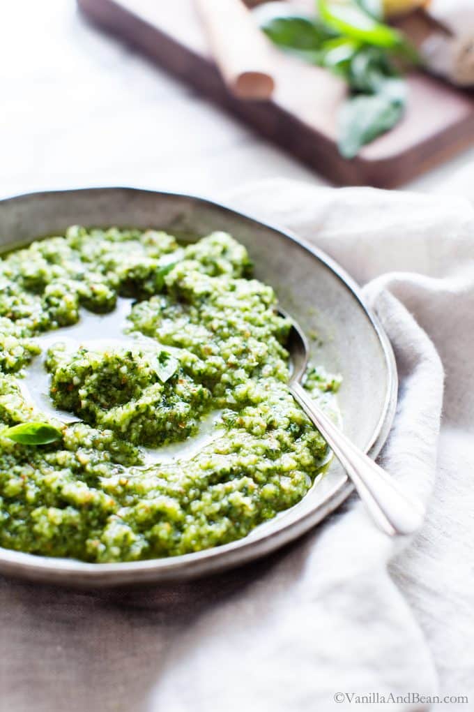 Pesto with almonds in a bowl with a spoon. 