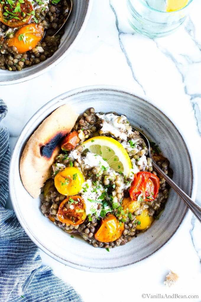 Mediterranean Lentils with Eggplant Recipe in a bowl with a spoon. 