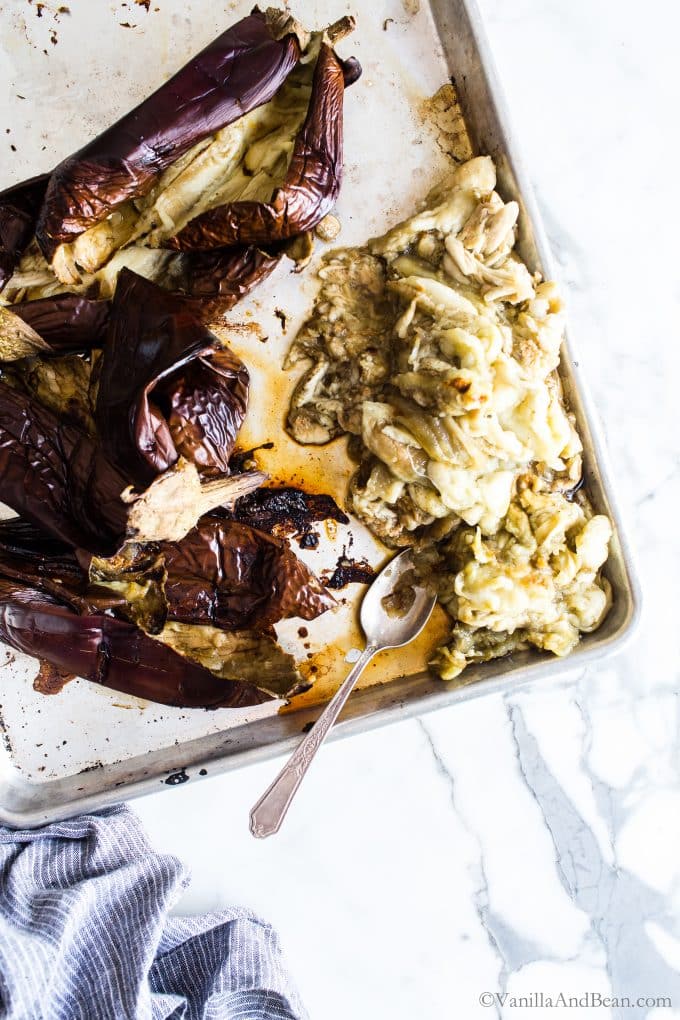 Roasted Eggplant on a parchment lined sheet pan. 