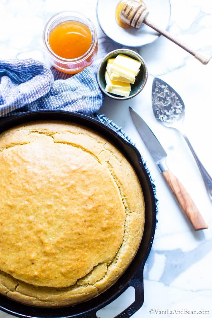 Gluten free cornbread in a cast iron skillet ready to be cut and served. 