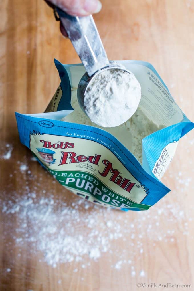 Scooping flour out of a bag. 