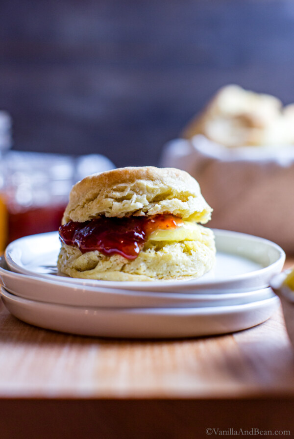 Sourdough discard biscuit with butter and jam on a plate.