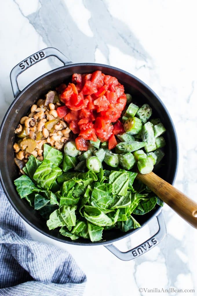 To the Cajun Vegetarian Black Eyed Peas, stir in the okra, tomatoes and collard greens. 