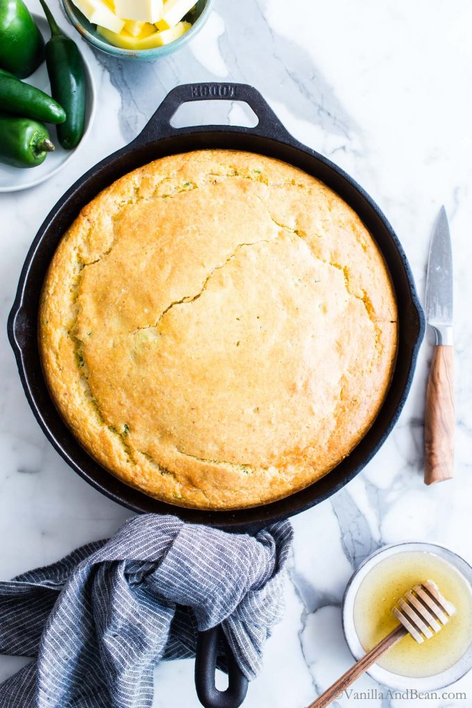 Jalapeño Cheddar Cornbread in a skillet ready for sharing.