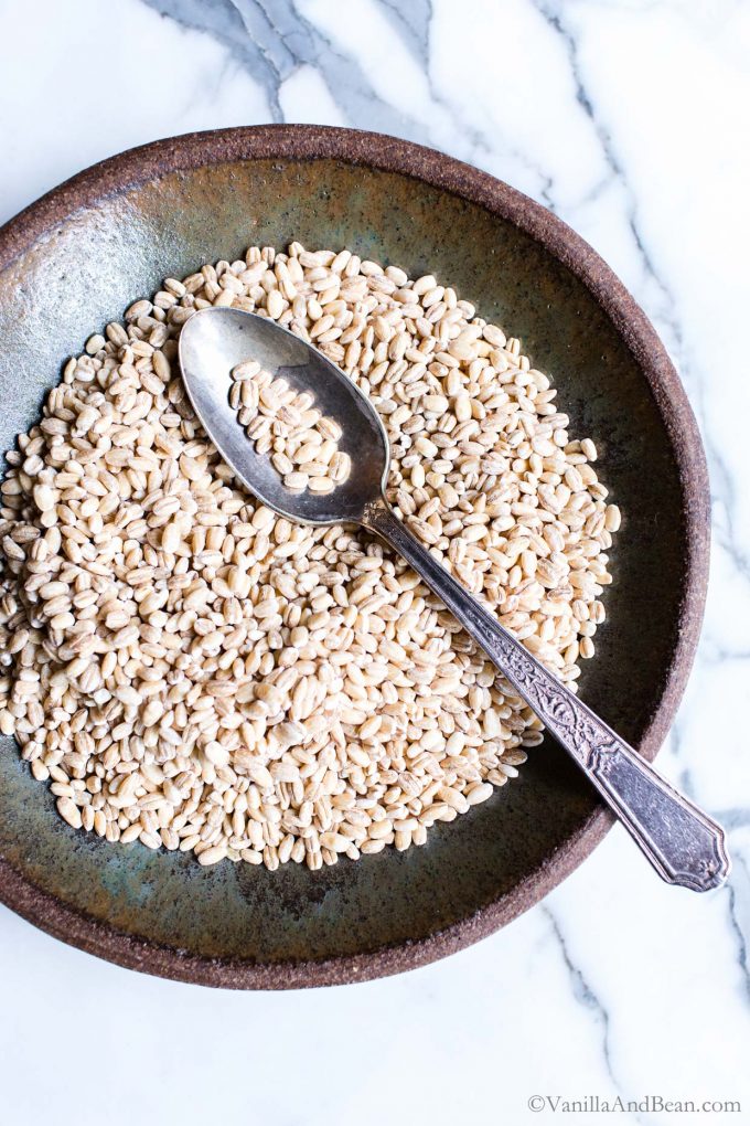 A bowl of wheat berries with a spoon. 