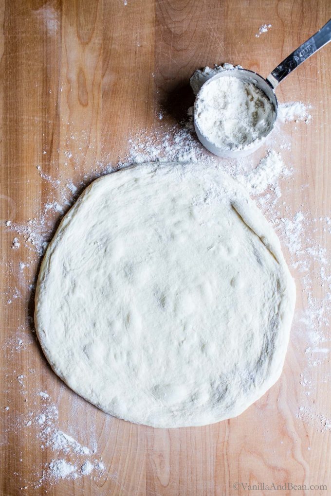 An 11" pizza dough crust shaped and ready for toppings.