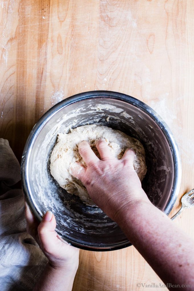 Kneading the dough in a mixing bowl.