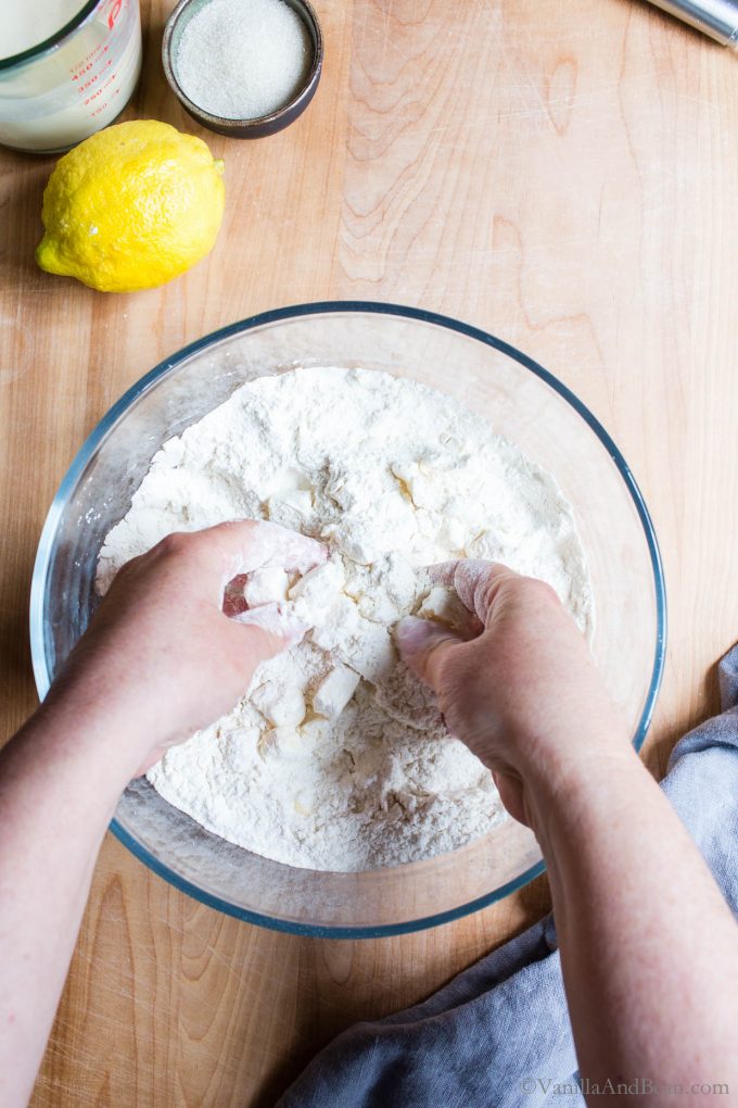 Cutting the butter into the flour using hands.