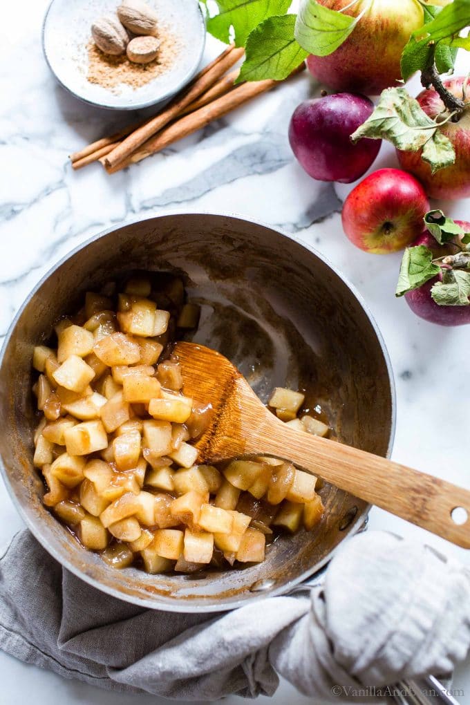 Stewed Apple Recipe in a pan with a spoon. 