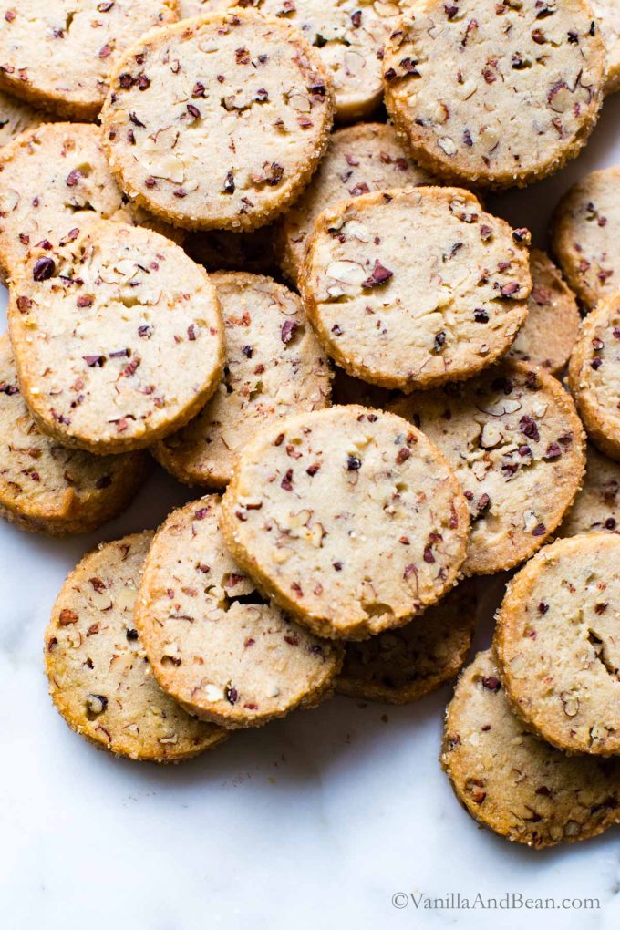A pile of pecan shortbread cookies on a table. 
